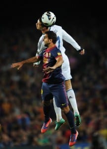 BARCELONA, SPAIN - OCTOBER 07: Cristiano Ronaldo (Top) of Real Madrid duels in the air for the ball with Martin Montoya of Barcelona during the la Liga match between FC Barcelona and Real Madrid at the Camp Nou stadium on October 7, 2012 in Barcelona, Spain. (Photo by Jasper Juinen/Getty Images)