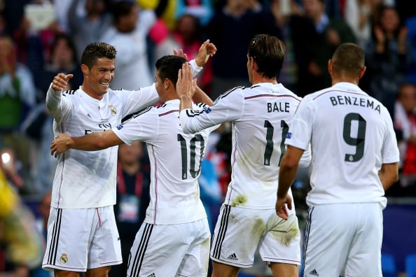 CARDIFF, WALES - AUGUST 12: (L-R) Cristiano Ronaldo of Real Madrid celebrates with teammates James Rodriguez, Gareth Bale and Karim Benzema after scoring the opening goal during the UEFA Super Cup between Real Madrid and Sevilla FC at Cardiff City Stadium on August 12, 2014 in Cardiff, Wales. (Photo by Clive Mason/Getty Images)