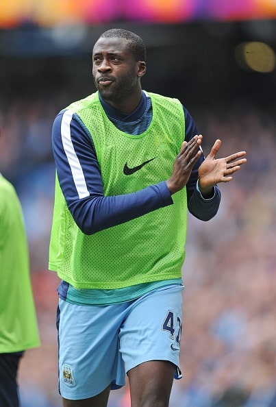 MANCHESTER, ENGLAND - MAY 10: Manchester City' hero Yaya Toure who is linked with a move from City applauds the crowd as they sing Happy Birthday to him as he warms up during the English Premier League match between Manchester City and Queens Park Rangers at The Etihad Stadium in Manchester, England on May 10, 2015. (Photo by Howard Walker/Anadolu Agency/Getty Images)