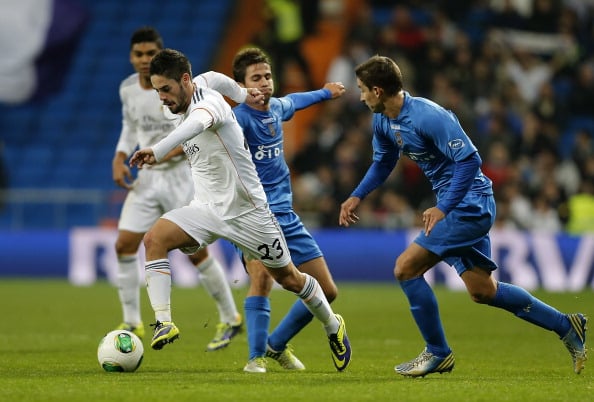 MADRID, SPAIN - DECEMBER 18: Isco of Real Madrid is challenged by Samuel Martinez (R) and Jordi Marenya during the Copa del Rey, round of 32 match between Real Madrid and Olimpic de Xativa at Estadio Santiago Bernabeu on December 18, 2013 in Madrid, Spain. (Photo by Angel Martinez/Real Madrid via Getty Images)
