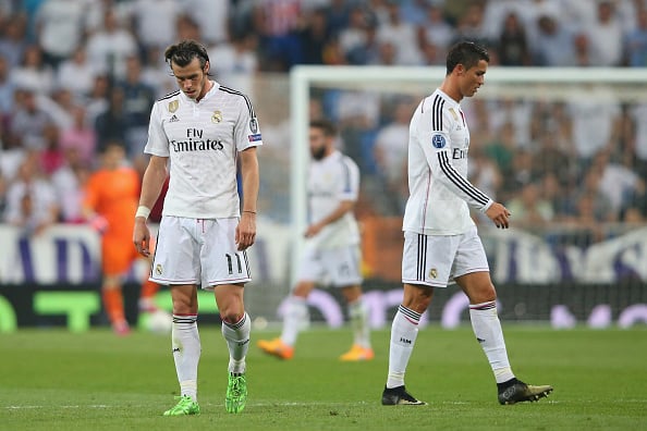 MADRID, SPAIN - MAY 13: (L-R) Dejected Real Madrid teammates Gareth Bale and Cristiano Ronaldo walk off the pitch following their team's exit from the competition during the UEFA Champions League Semi Final, second leg match between Real Madrid and Juventus at Estadio Santiago Bernabeu on May 13, 2015 in Madrid, Spain. (Photo by Alex Livesey/Getty Images)
