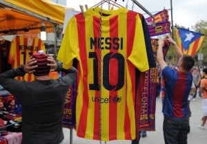 BARCELONA, SPAIN - OCTOBER 26: A Lionel Messi FC Barcelona shirt hangs from a merchandise shop before the La Liga match between FC Barcelona and Real Madrid CF at Camp Nou stadium on October 26, 2013 in Barcelona, Spain. (Photo by Denis Doyle/Getty Images)