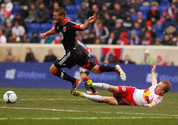 HARRISON, NJ - MARCH 16: Perry Kitchen #23 of D.C. United is tripped up by Dax McCarty #11 of New York Red Bulls at Red Bull Arena on March 16, 2013 in Harrison, New Jersey. Red Bulls and DC United play to a 0-0 draw. (Photo by Mike Stobe/Getty Images)