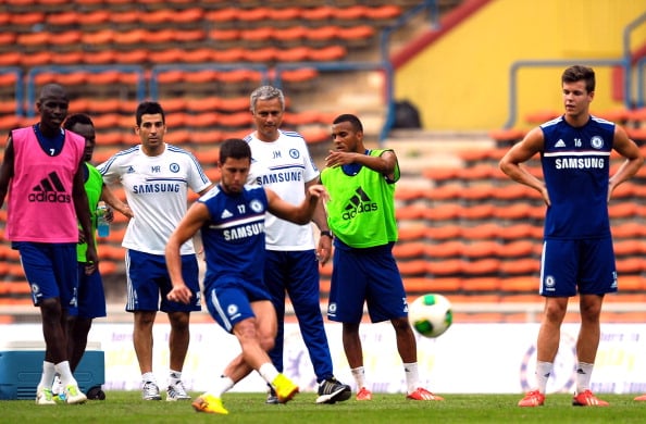 KUALA LUMPUR, MALAYSIA - JULY 20: Eden Hazard of Chelsea takes a penalty kick practice while Jose Mourinho and team-mates looks on during a Chelsea FC training session at the Shah Alam Stadium in Shah Alam on July 20, 2013 in Kuala Lumpur, Malaysia. (Photo by Stanley Chou/Getty Images)