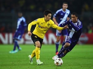 DORTMUND, GERMANY - DECEMBER 09: Shinji Kagawa of Borussia Dortmund is closed down by Youri Tielemans of Anderlecht during the UEFA Champions League Group D match between Borussia Dortmund and RSC Anderlecht at Signal Iduna Park on December 9, 2014 in Dortmund, Germany. (Photo by Dennis Grombkowski/Bongarts/Getty Images)