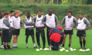 ST ALBANS, ENGLAND - SEPTEMBER 14: Arsenal manager Arsene Wenger talks to his players (L-R) Freddie Ljungberg, Martin Keown, Ray Parlour, Lauren, Thierry Henry, Patrick Vieira, Robert Pires and Gio van Bronkhurst during a training session at London Colney on September 14, 2001 in St Albans, England. (Photo by Stuart MacFarlane/Arsenal FC via Getty Images)