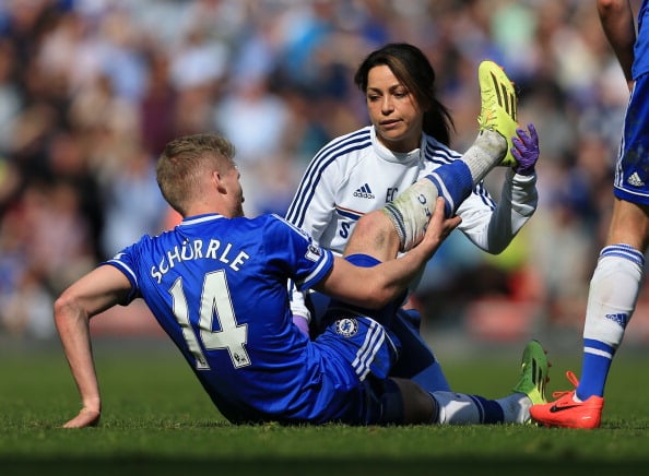 LIVERPOOL, ENGLAND - APRIL 27: Andre Schurrle of Chelsea receives treatment from Chelsea physio Eva Carneiro during the Barclays Premier League match between Liverpool and Chelsea at Anfield on April 27, 2014 in Liverpool, England. (Photo by Simon Stacpoole/Mark Leech Sports Photography/Getty Images)