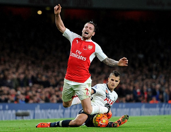 LONDON, ENGLAND - NOVEMBER 08:  Mathieu Debuchy of Arsenal is fouled by Erik Lamela of Tottenham during the Barclays Premier League match between Arsenal and Tottenham Hotspur at Emirates Stadium on November 8, 2015 in London, England.  (Photo by David Price/Arsenal FC via Getty Images)